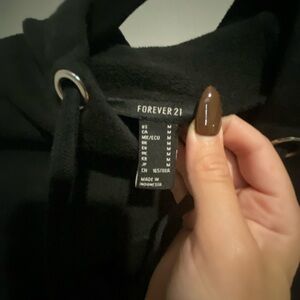 Black cropped sweater with hoodie, open cut in the chest area